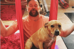 Lehmo with his dog Buddy trying Arial Yoga